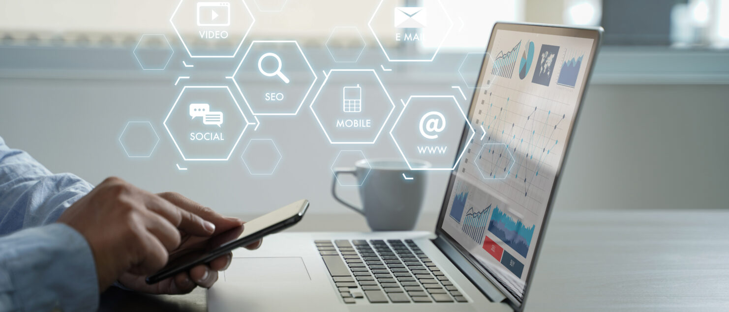 man on phone and computer, website seo ranking and marketing