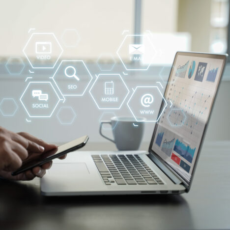 man on phone and computer, website seo ranking and marketing